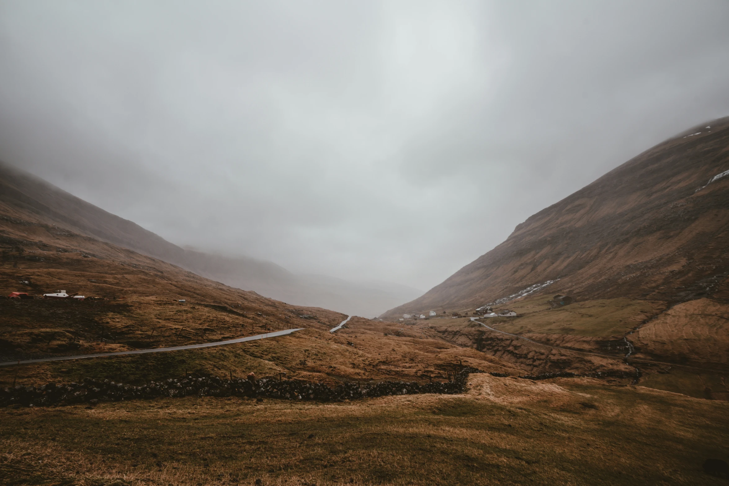 a mountain in the distance with a road winding through it