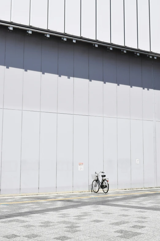 there are two bicycles in front of the wall