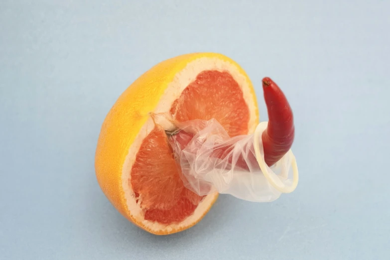 an orange sliced in half on a light blue surface