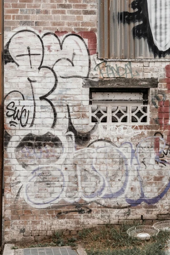 graffiti painted on a brick wall near a window
