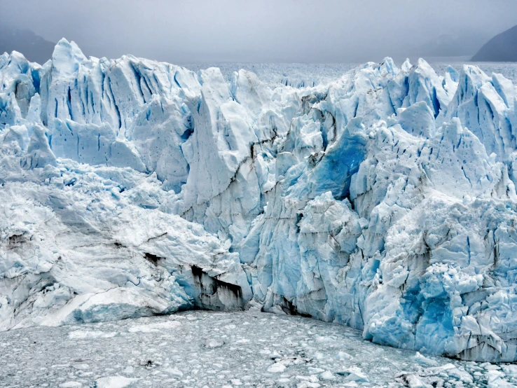 a glacier wall is covered in blue ice