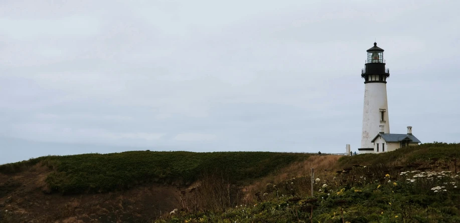 a light house sitting on the side of a cliff