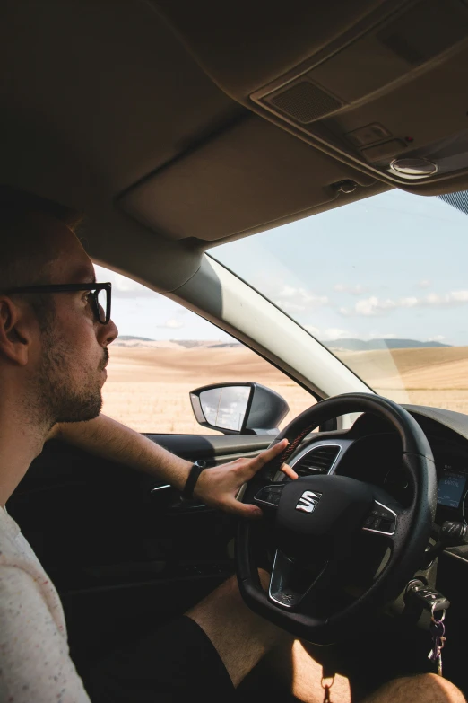 a man sitting in the driver's seat of a car