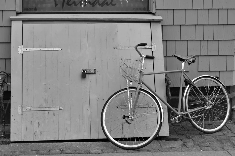 a bicycle that is standing against a building