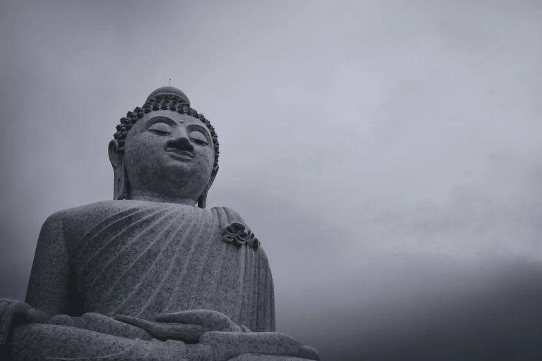 buddha statue with fog in the background