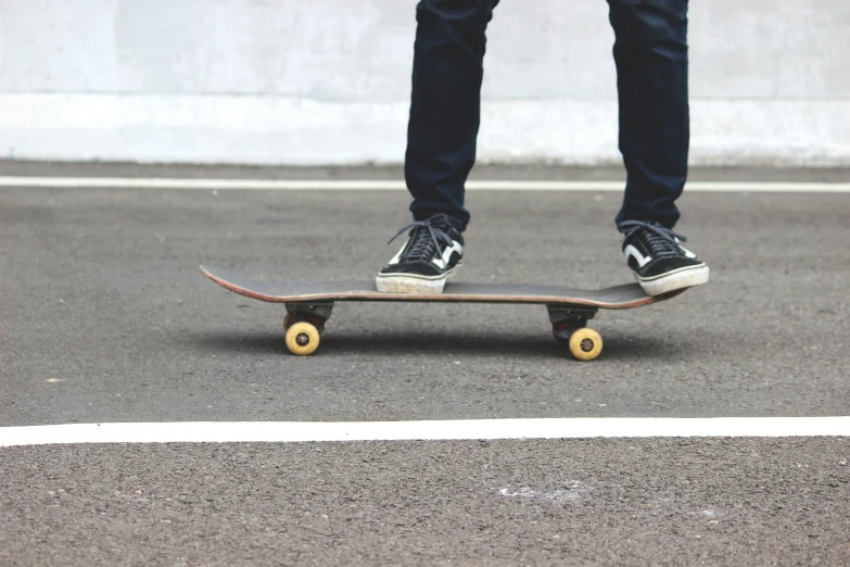 a person standing on top of a skateboard on a city street