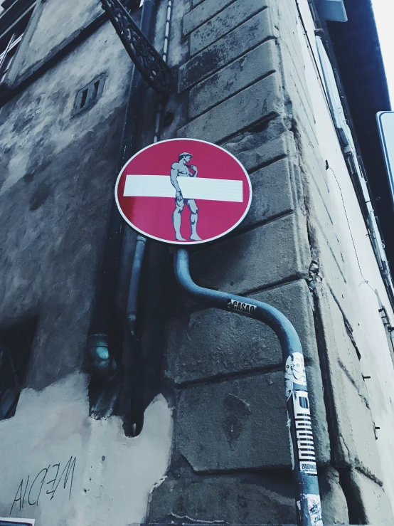 a red and white street sign next to a building