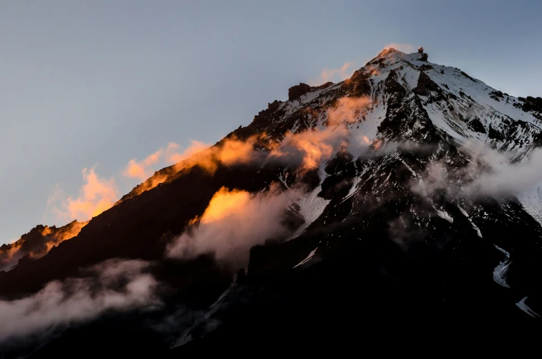 a view of clouds on a mountain top