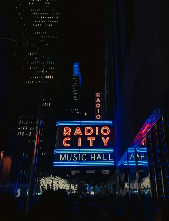 the radio city music hall marquee lit up at night