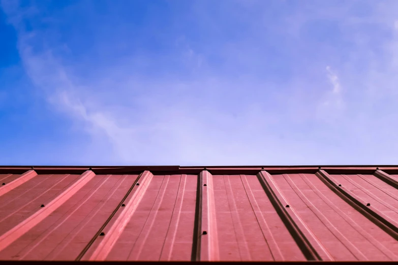 the top of a red building with a metal roof