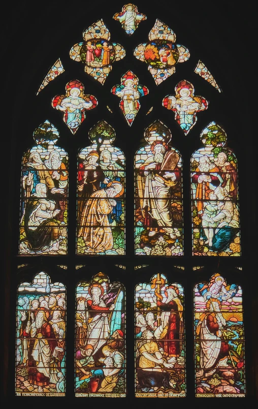 a stained glass window that has pictures on it