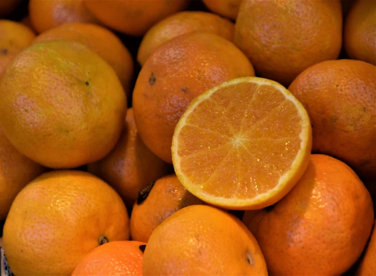 oranges sitting around in a pile on a table