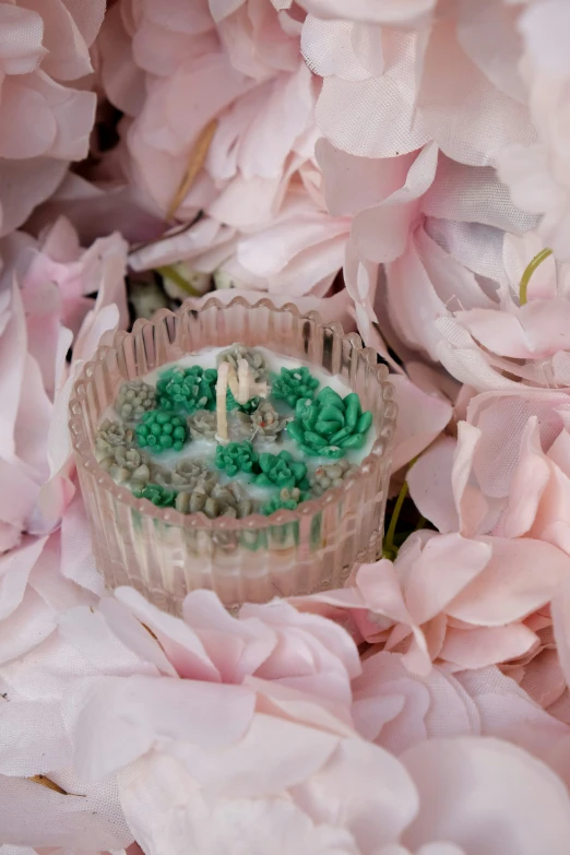 a cupcake sits in between some flowers