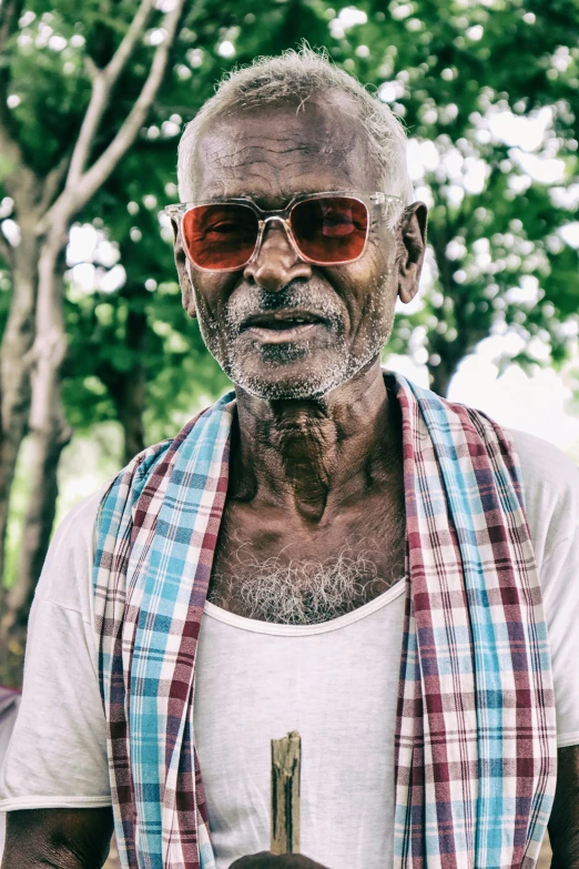 an older man with a beard wearing red sunglasses