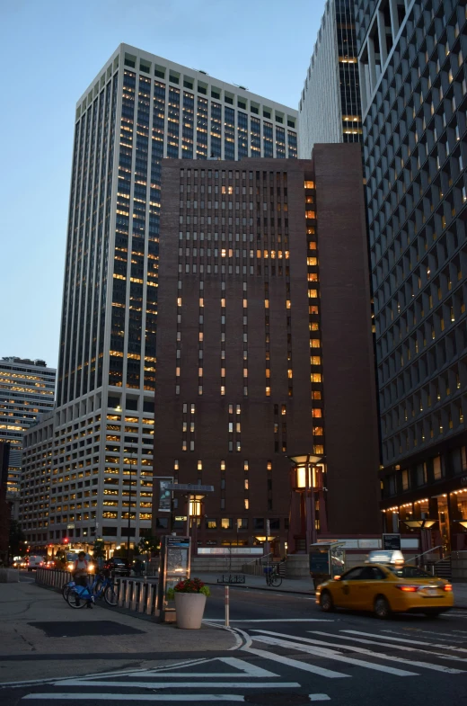 a view of tall buildings with lit up windows