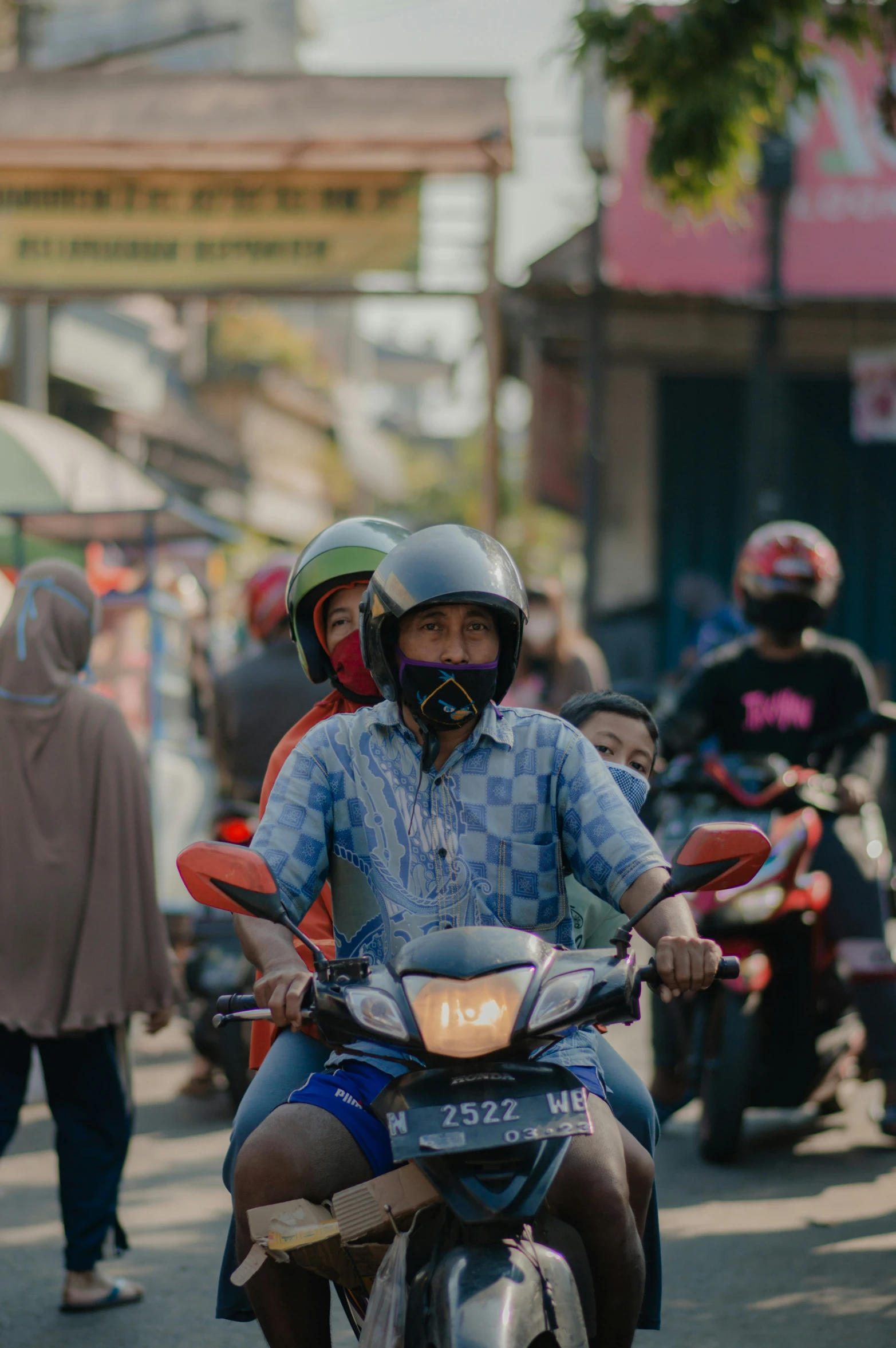 the two men on the motorcycle are talking on the phone