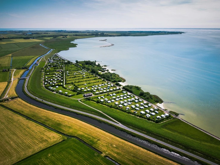 a land with several homes next to the water