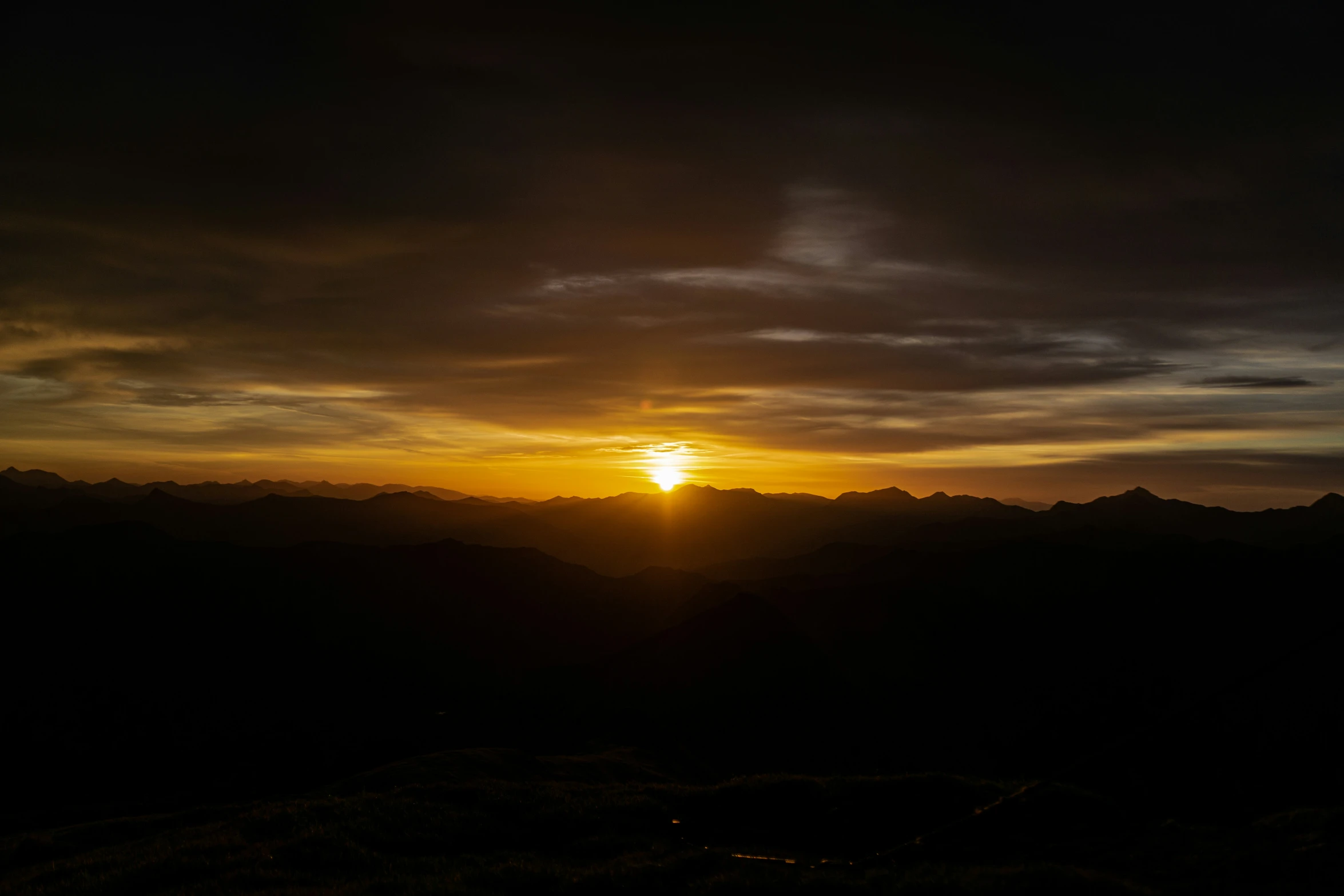 a view of the sunset in a mountain range