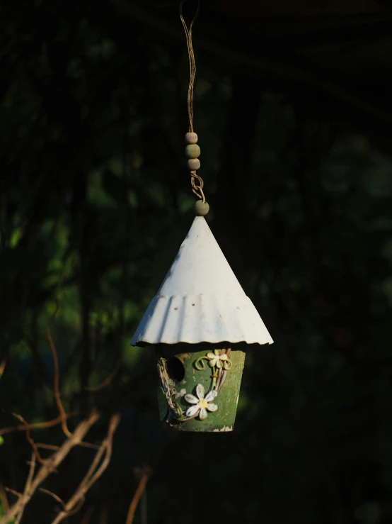 a hanging bird house that is made from cardboard