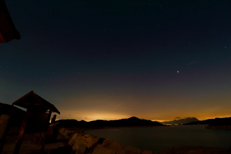 a clear night sky and a lake below it