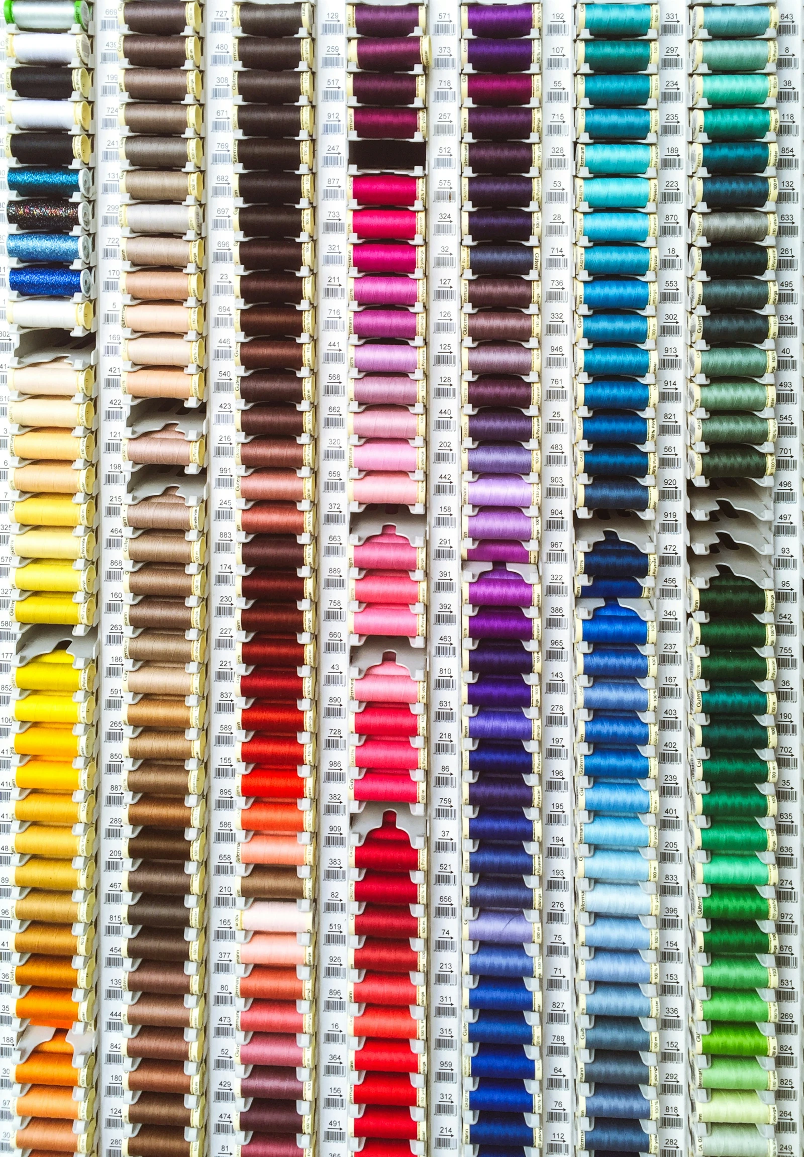 many different colored markers sitting on a white surface