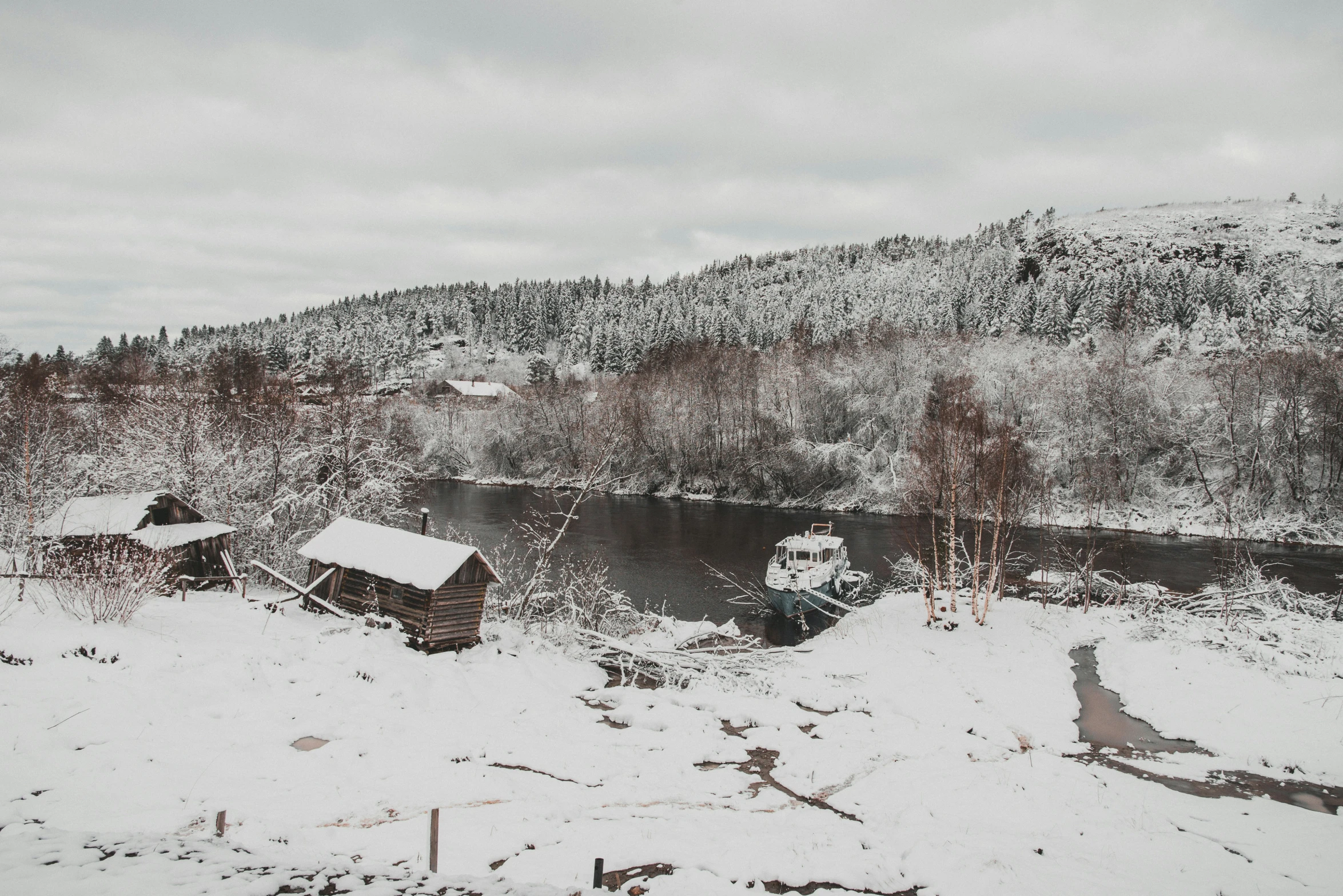 winter scene of snow covered hills and small buildings