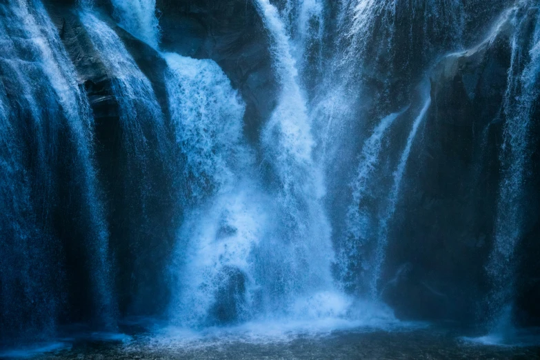 a large waterfall is shown with blue paint