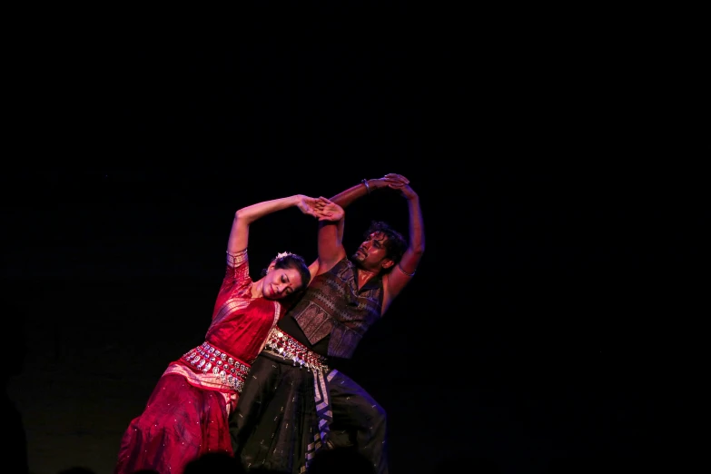 dancers perform a dance act in the dark