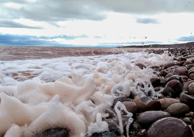 this is a rocky beach with water and ice