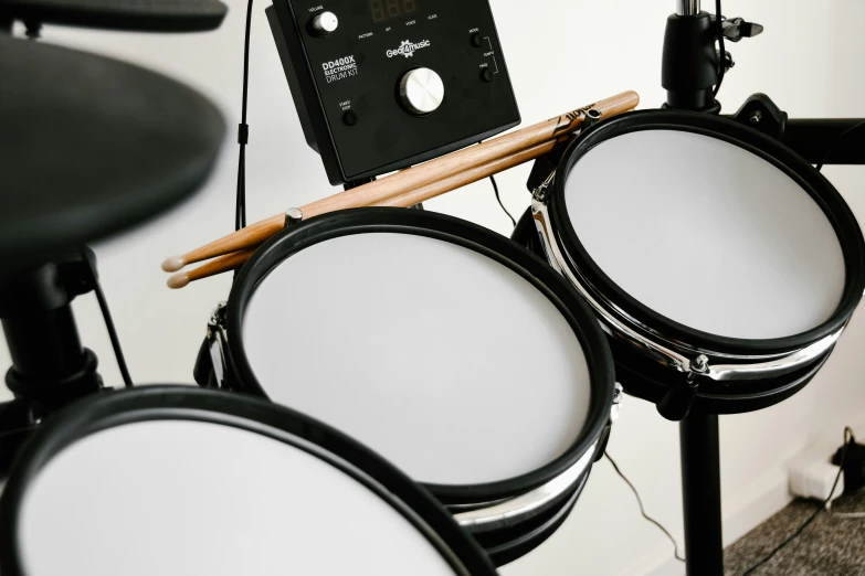 a drum kit sitting next to a wall