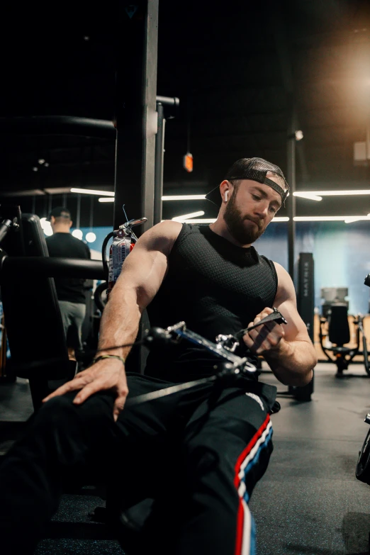 a man sitting down in a gym