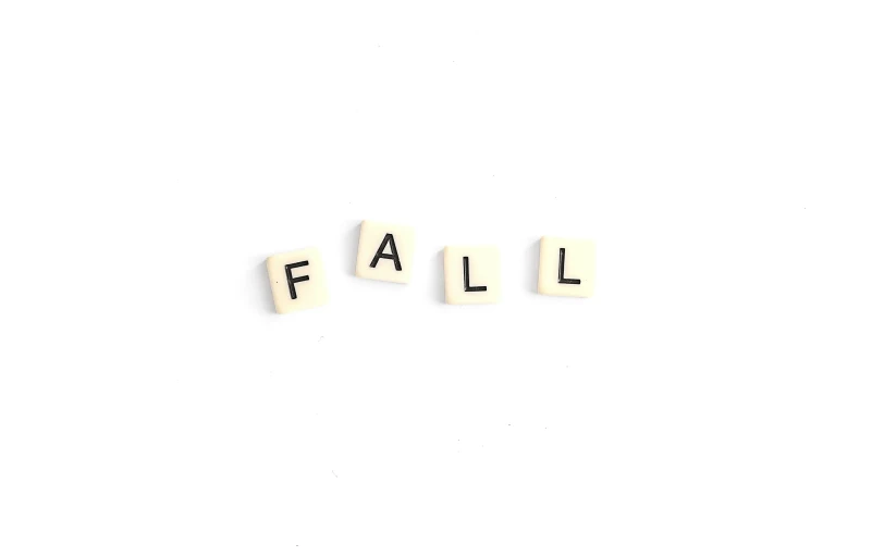 white pieces of cut up letters spelling fall