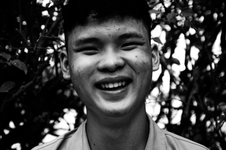 a black and white po of a smiling young man