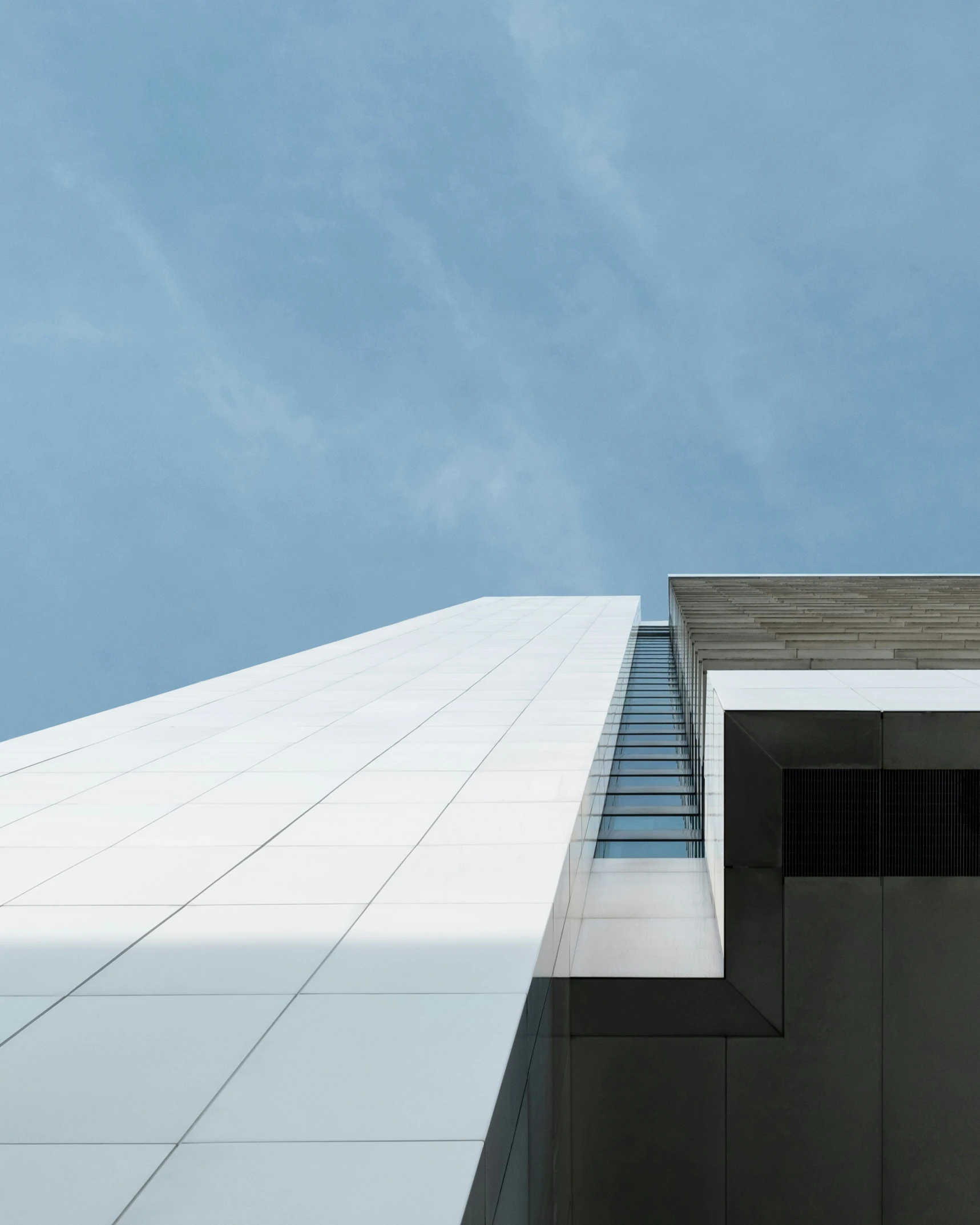 an airplane flies past the top of the building