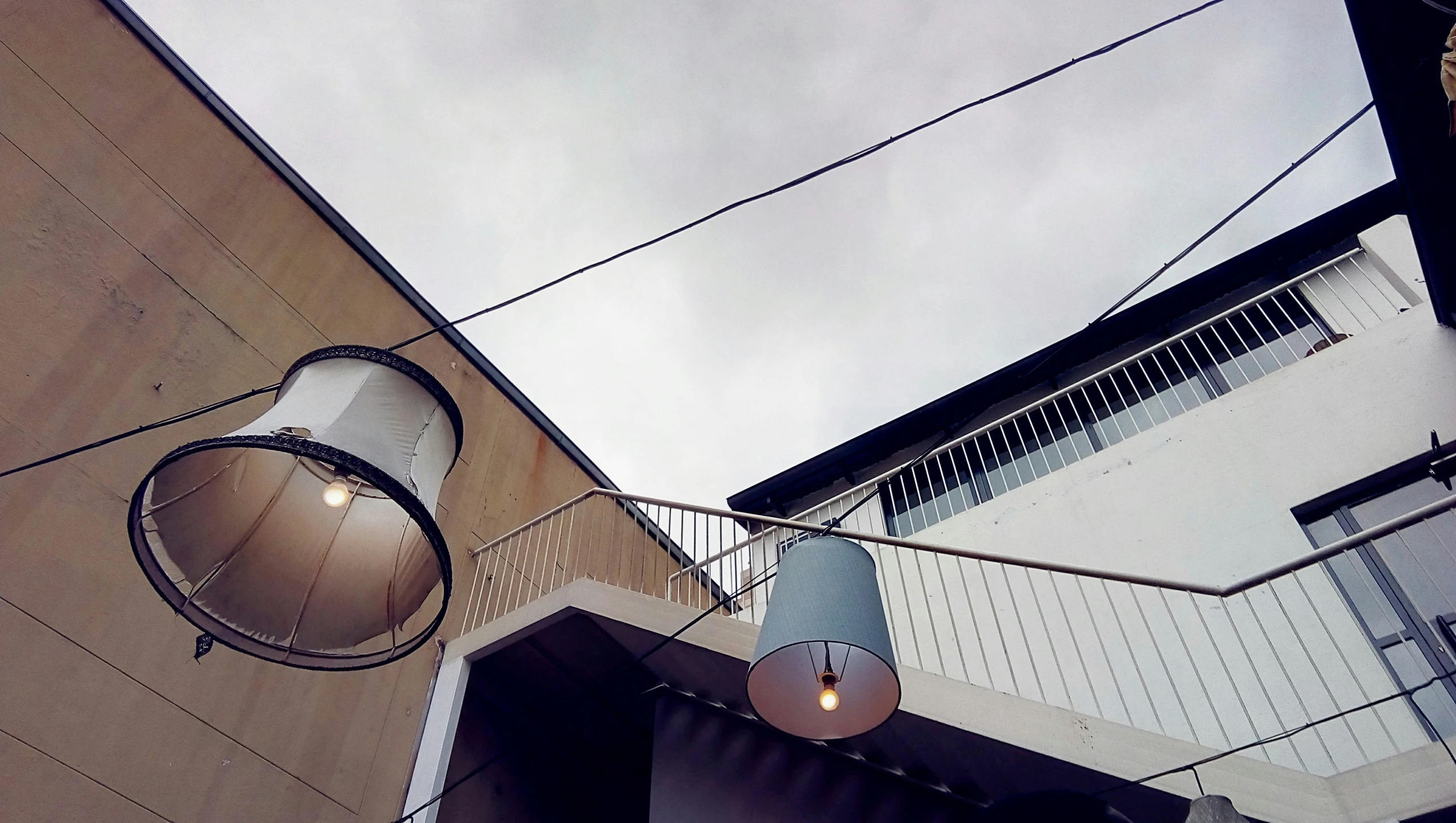 some very pretty looking lamps hanging from a street