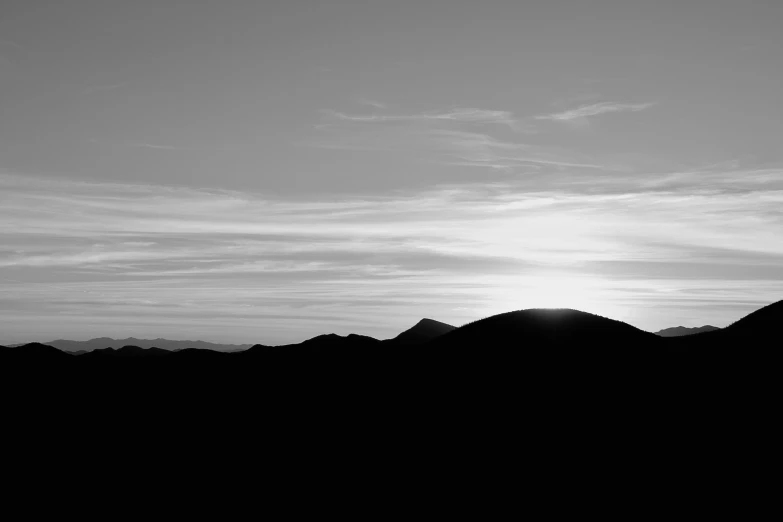 the sun shines through the clouds above the mountain