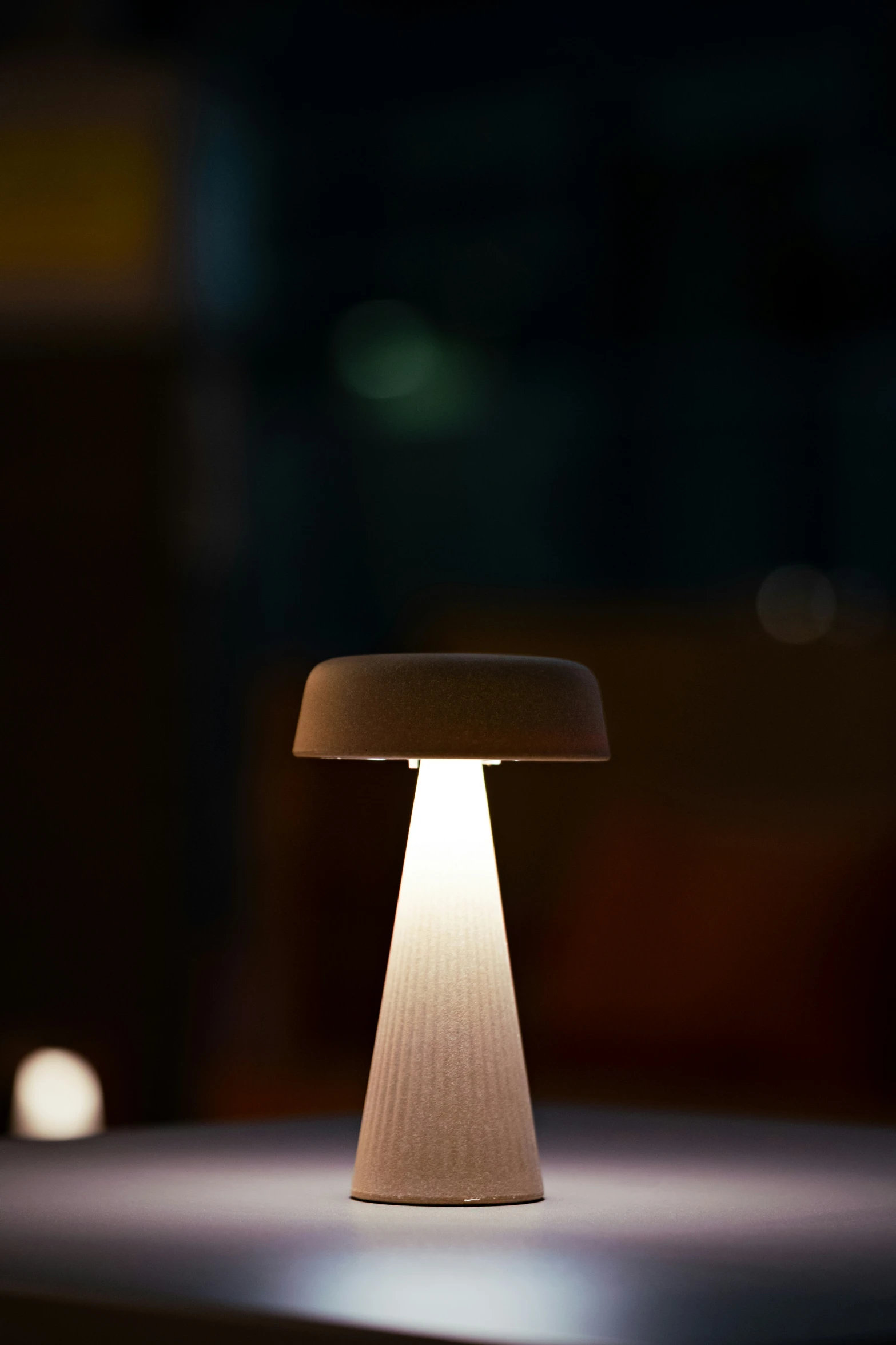 a mushroom shaped lamp with a beige fabric shade