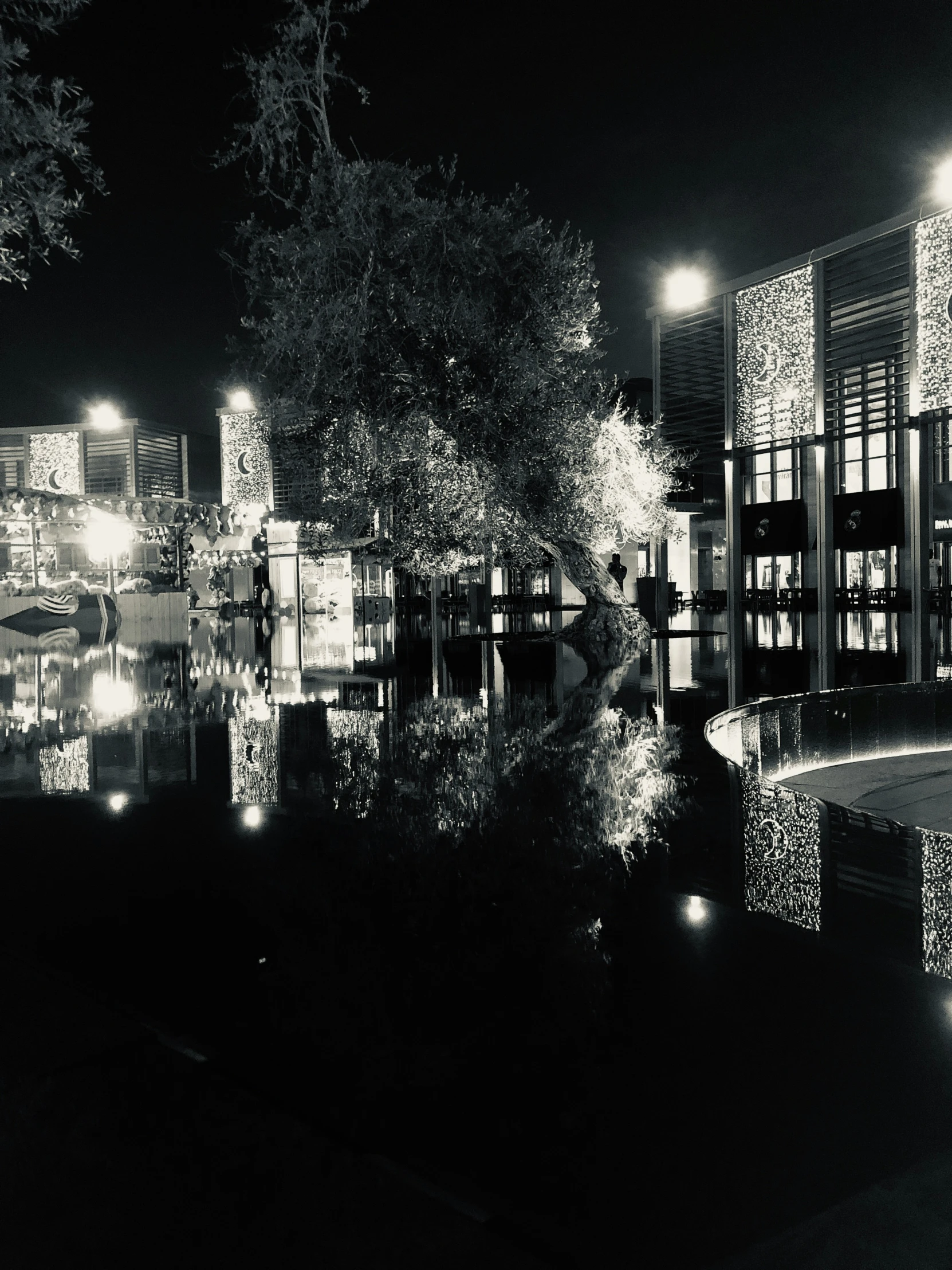 a large building with lots of windows near a lake