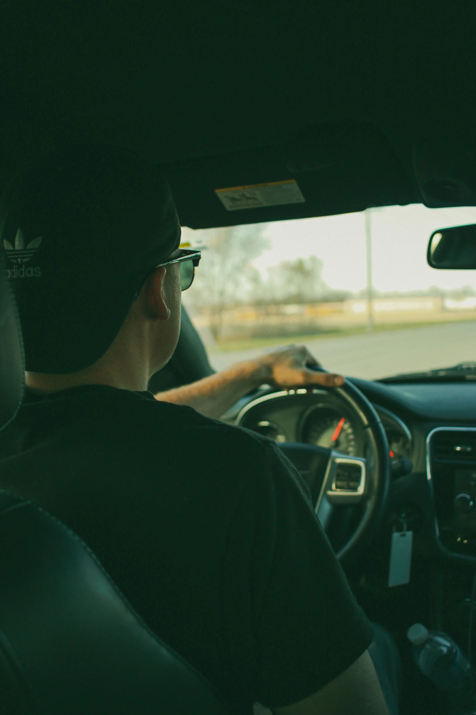 a man driving his car through traffic on the road