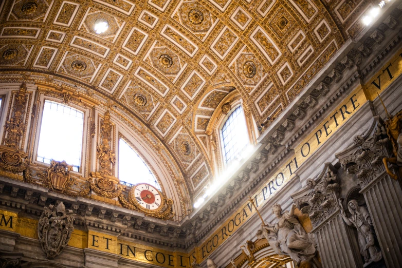 a ceiling inside of a building with a clock