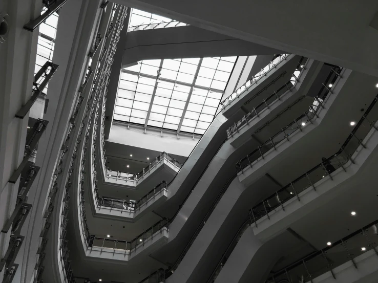 multiple level of stairs in a building with high ceilings