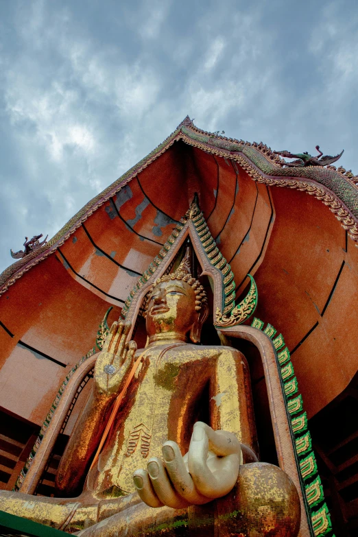 the back side of a gold buddha statue