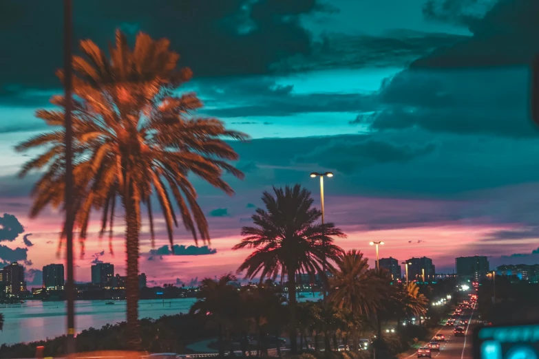 the view of a city street at sunset