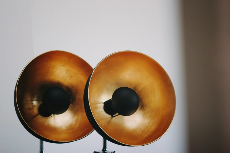 a close up of two gold metal speakers