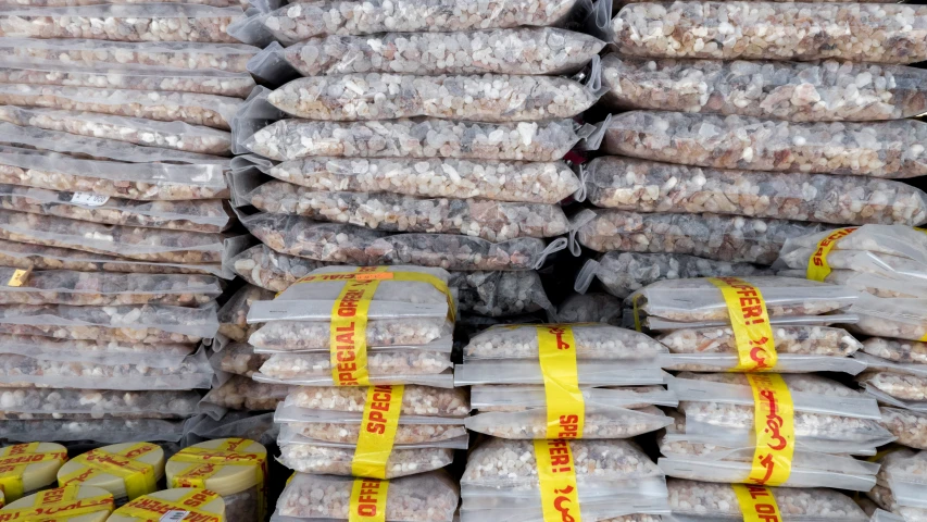 a large pile of rice in plastic bags