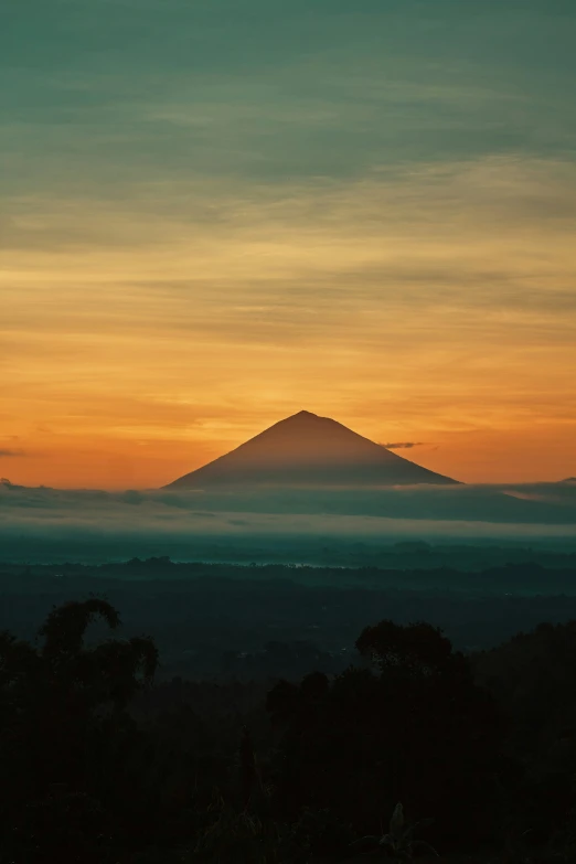 the sun rising over the mountains and the hills