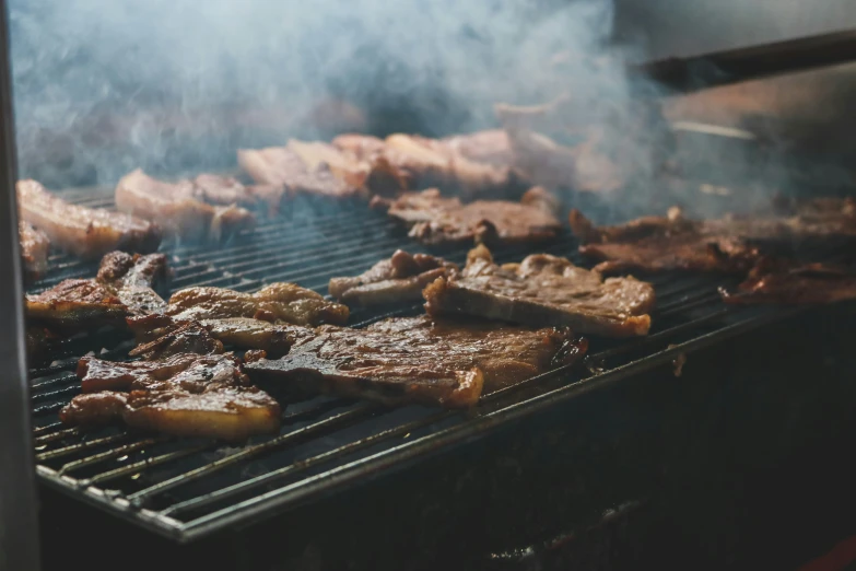 some meat is cooking on the grill and being cooked