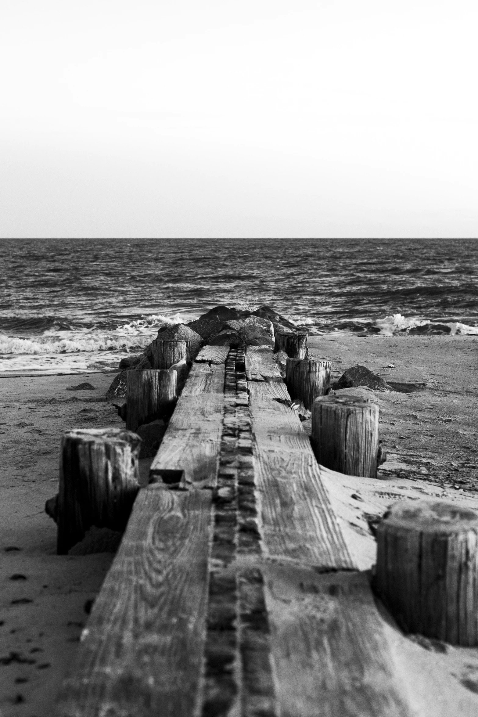 the benches on the shore have logs on them