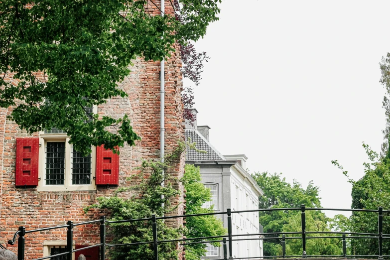 an old brick building has a wooden fence surrounding it