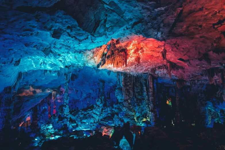 an image of a beautiful cave with many colorful lights on the ceiling